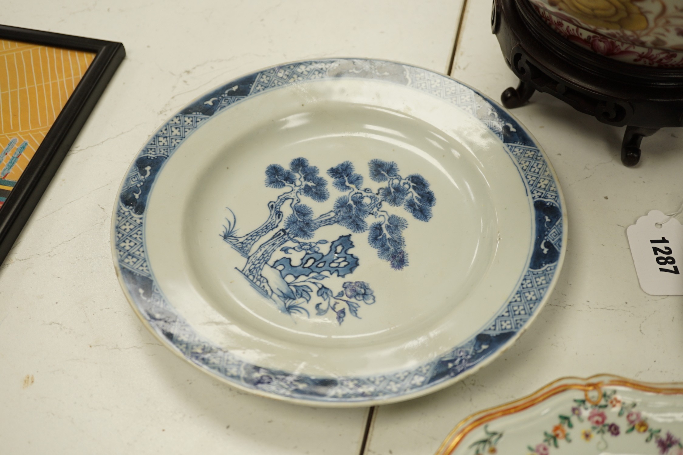 A Chinese export armorial soup plate, for the Spanish market, Qianlong period, with a Spanish coat of arms, possibly Aguado de Las Marismas, an 18th century Chinese export punch bowl on stand, a Chinese blue and white pl